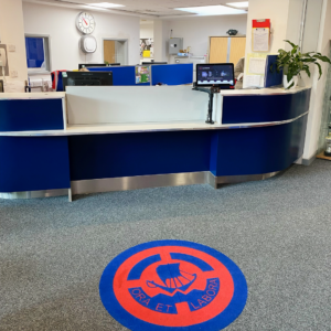 High school reception area with EntrySign desk-mounted screen installed