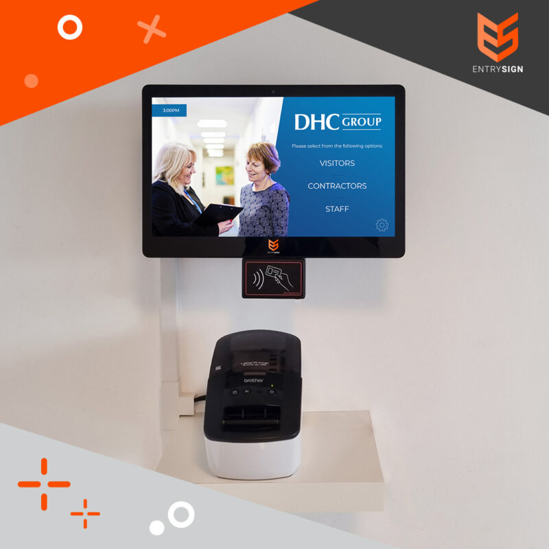 Visitor management screen with a blue user interface and installed on a white wall.
