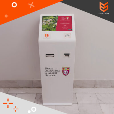 School visitor management kiosk in white with red user interface and front logo.