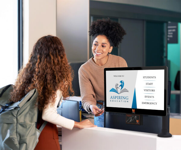 Woman and student with a visitor management screen to the side